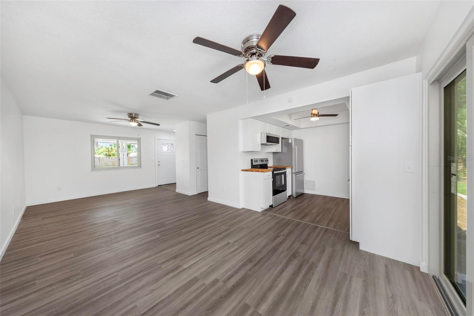 Open living area and kitchen with sliding door access to covered lanai