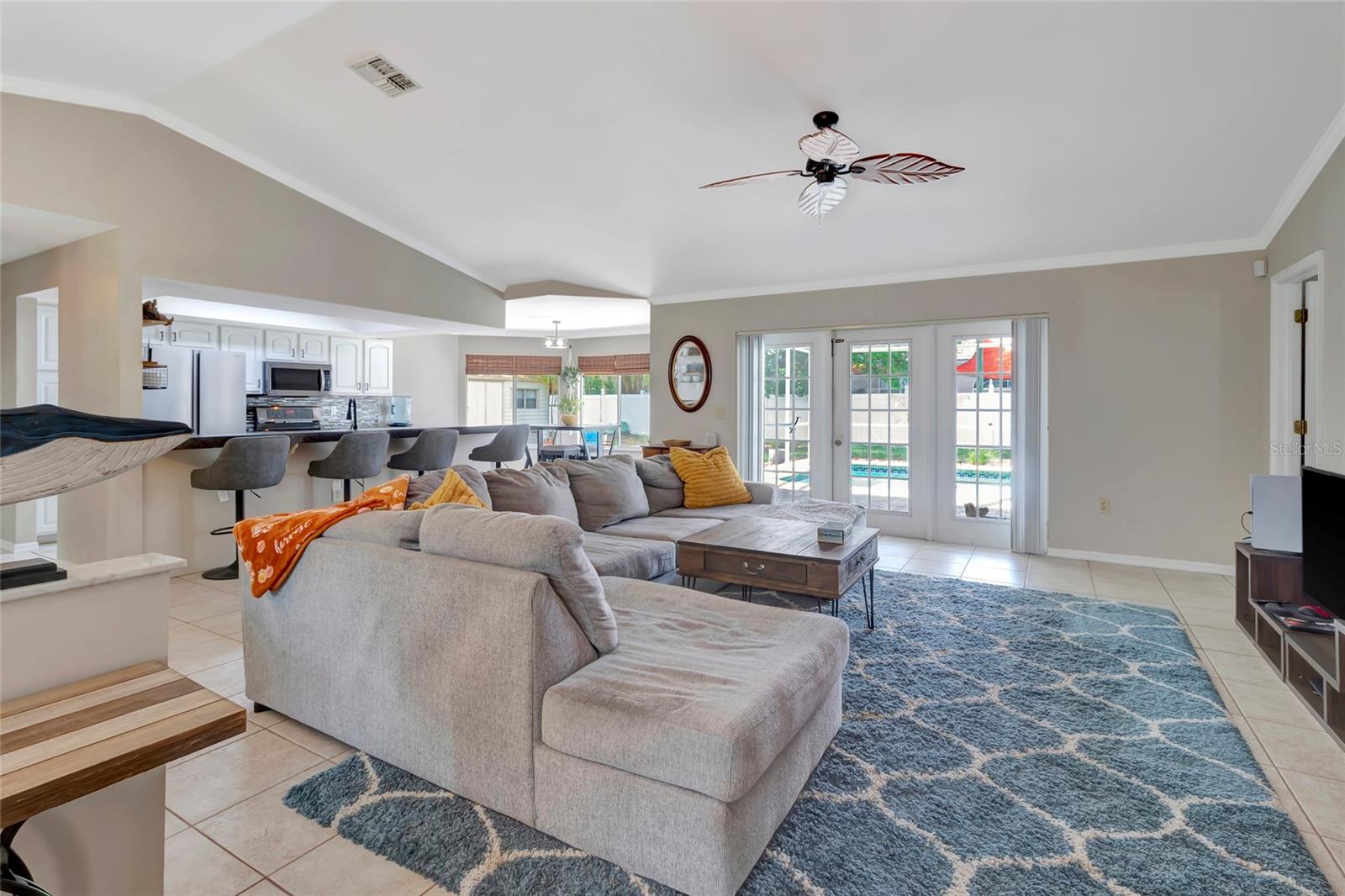Living Room with Ceiling fan and tile