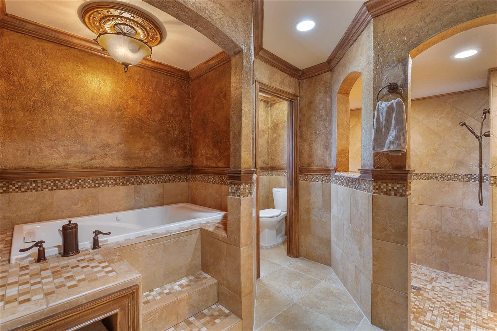 Elegant soaking tub in master bedroom