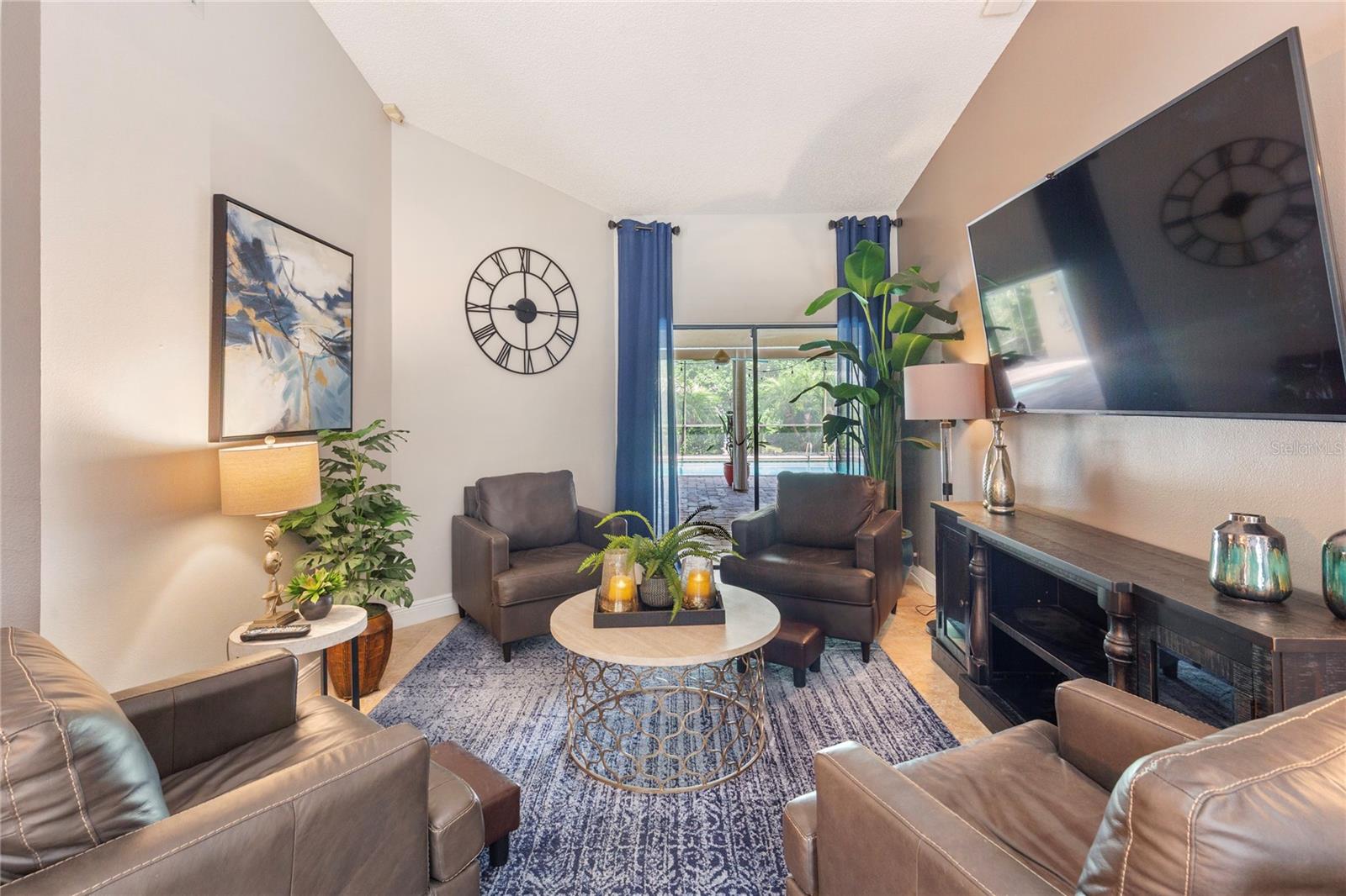 View from front entrance into formal living room or dining room looking onto the lanai and pool