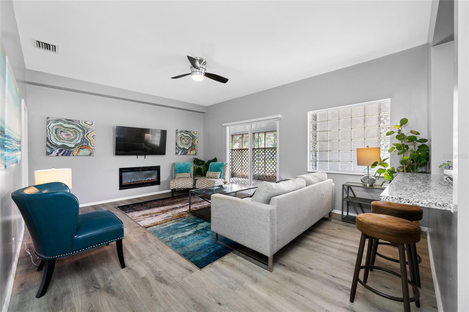 Living Room with electric fireplace and sliding door to the front screened porch