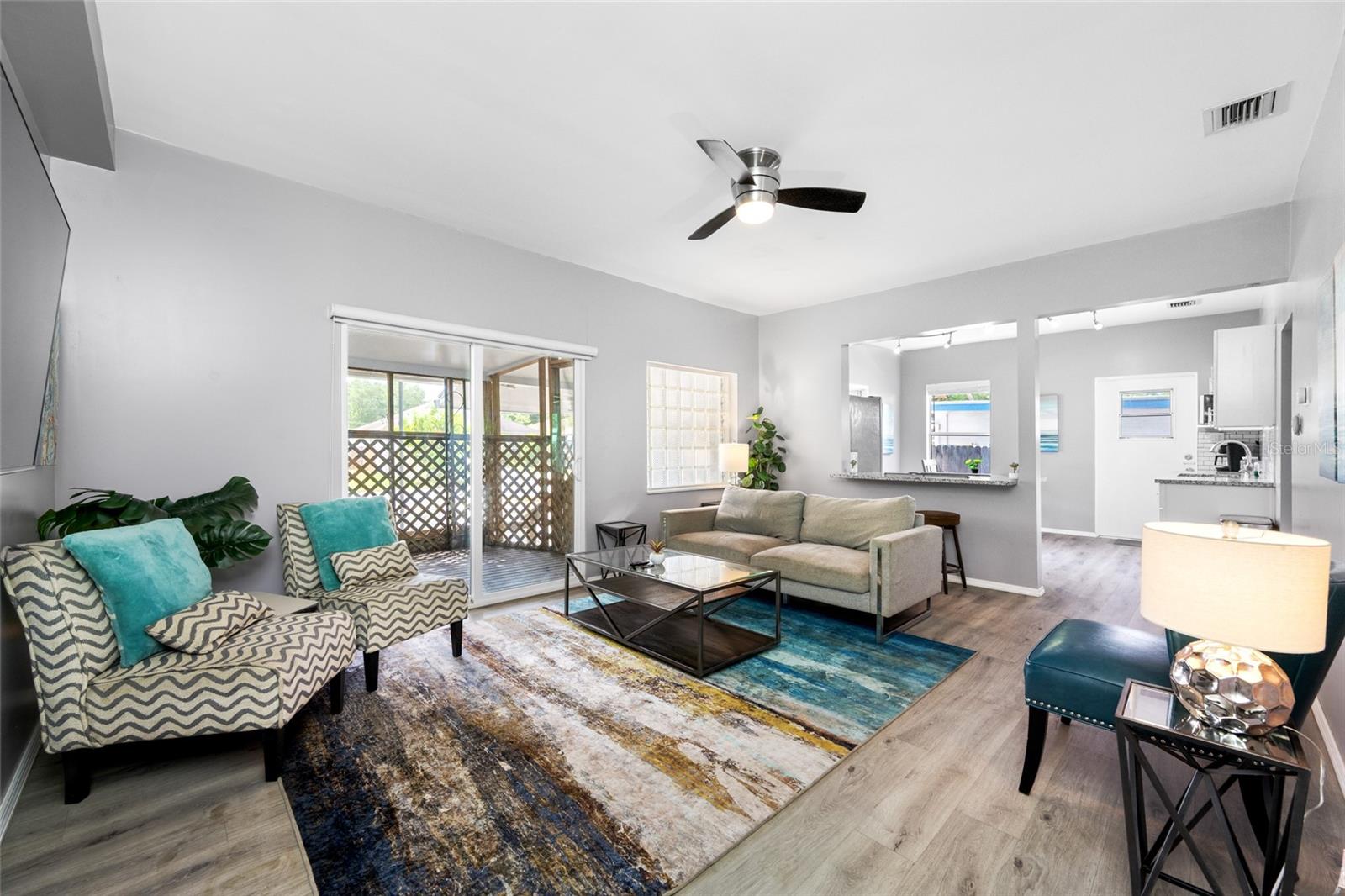Living Room with electric fireplace and sliding door to the front screened porch