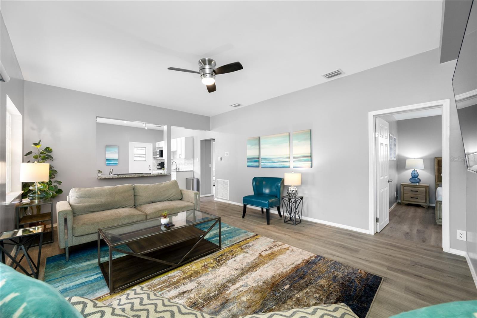 Living Room with electric fireplace and sliding door to the front screened porch