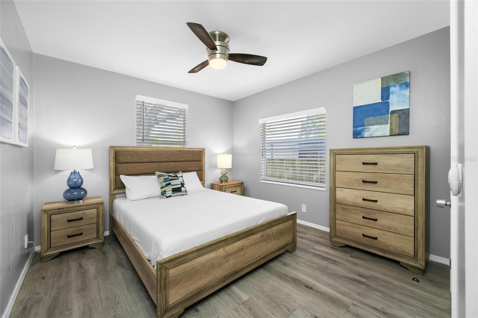 Primary Bedroom suite with walk-in closet, with built in shevles, that opens through to private en-suite updated bathroom with marble tile and glass shower.
