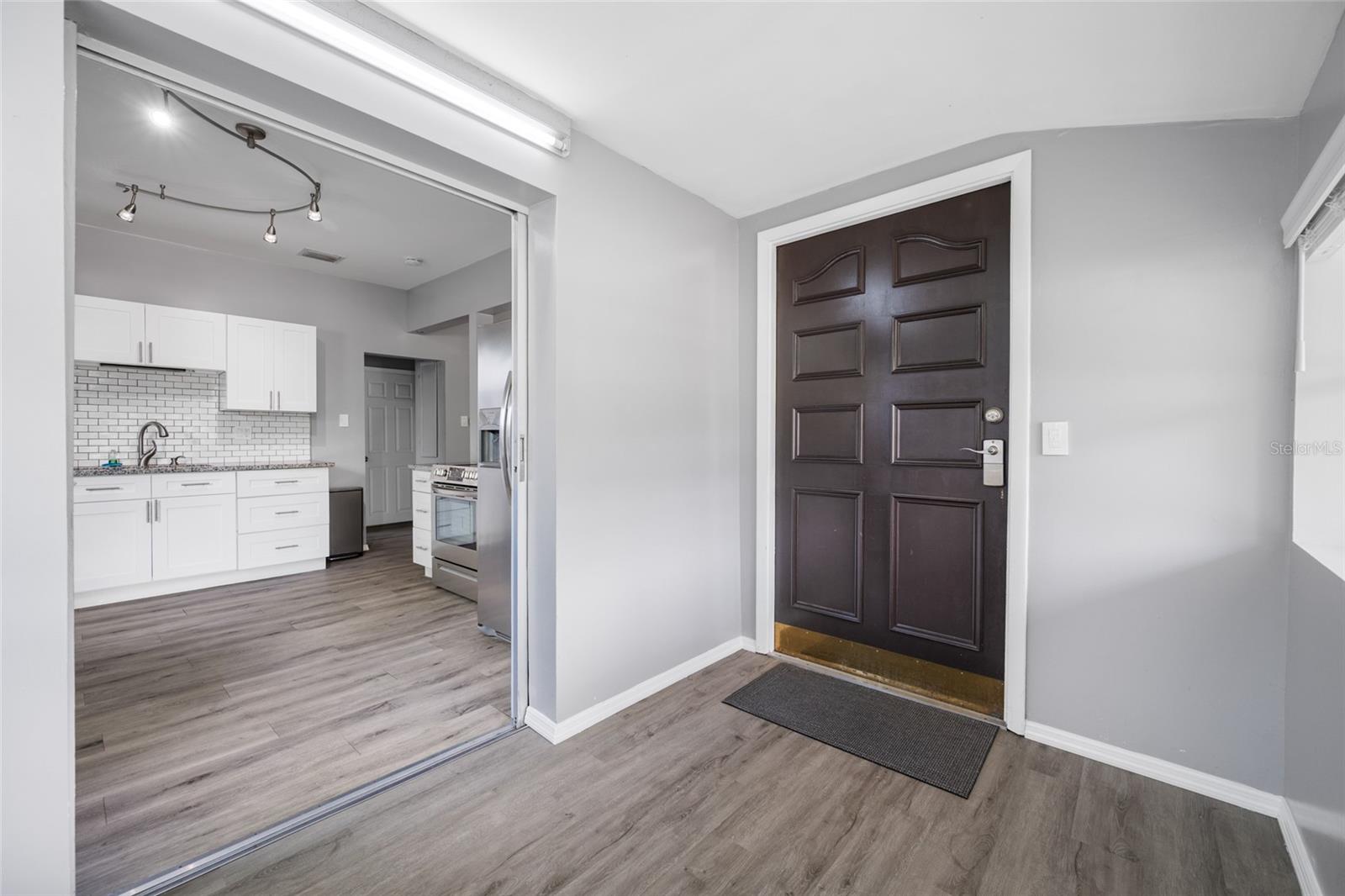 Front door opens into Foyer / mudroom with W/D, large shelf, and has a pocket door to keep noise down.