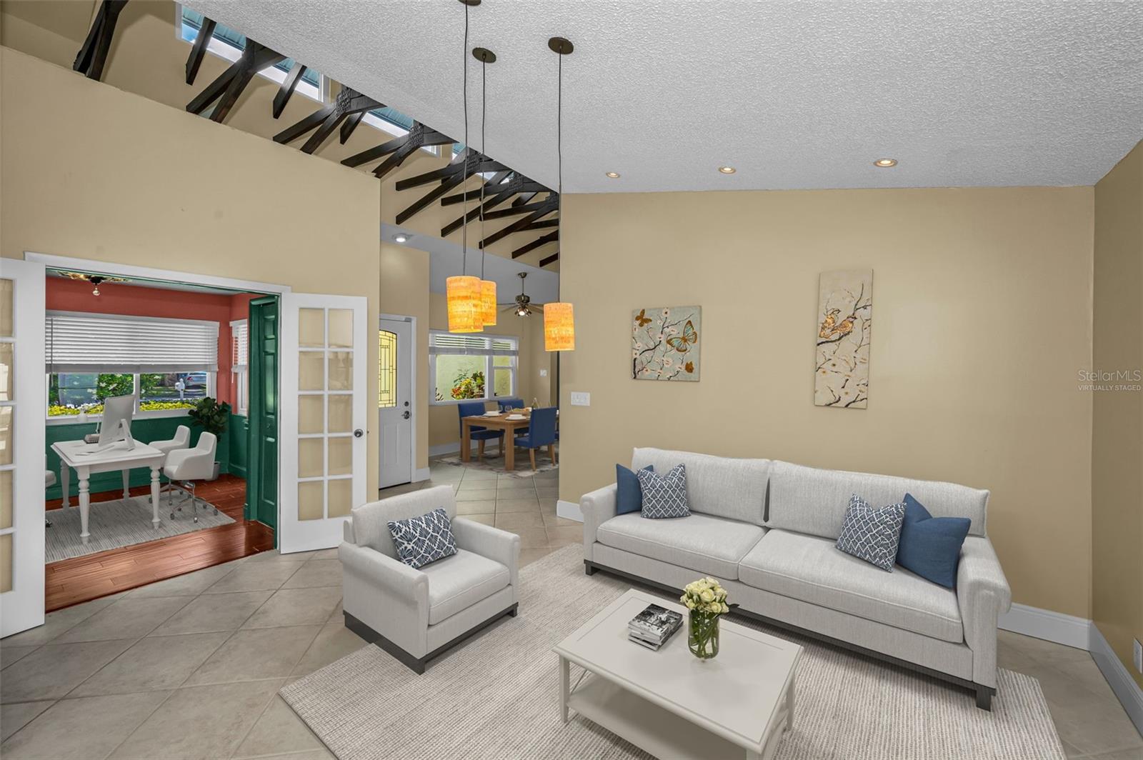 Virtually staged living room adjacent to office/bedroom