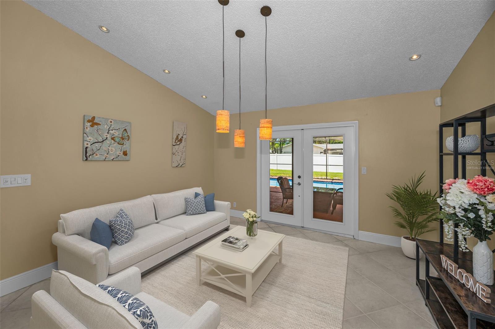 Virtually staged living room w/French doors to Lanai