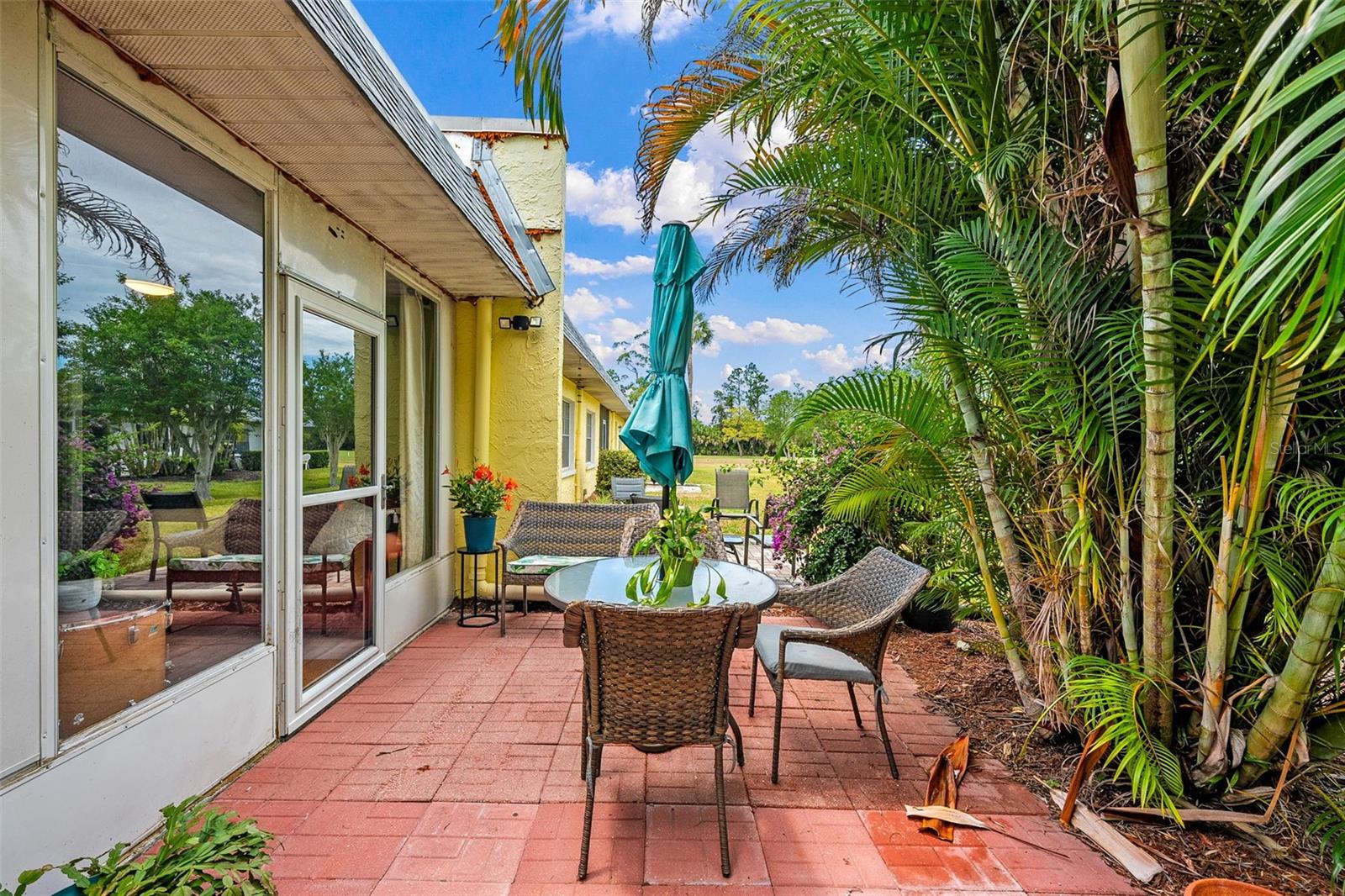Lush tropical pavered patio with golf course views