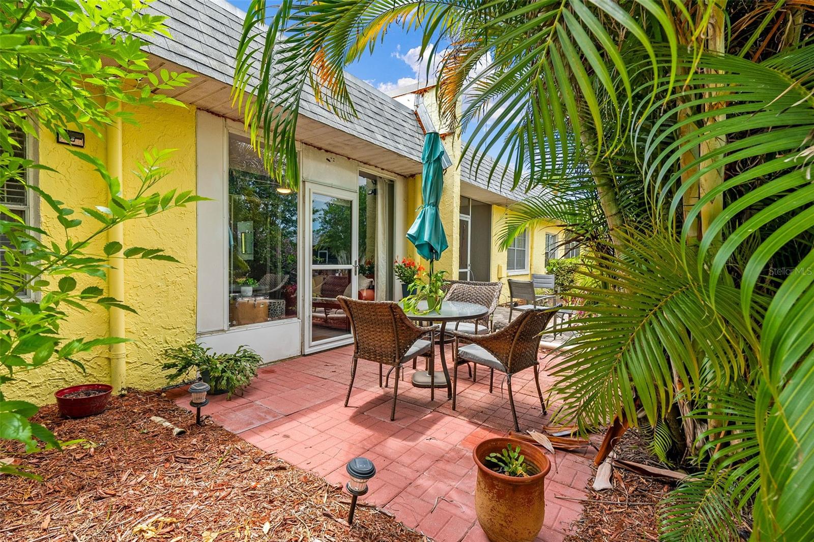 Lush tropical pavered patio