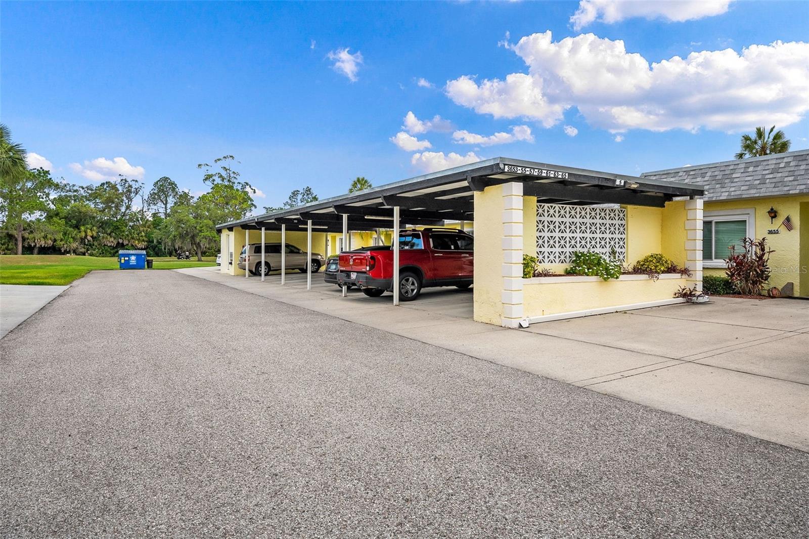 Owner's covered parking and additional guest parking to the right
