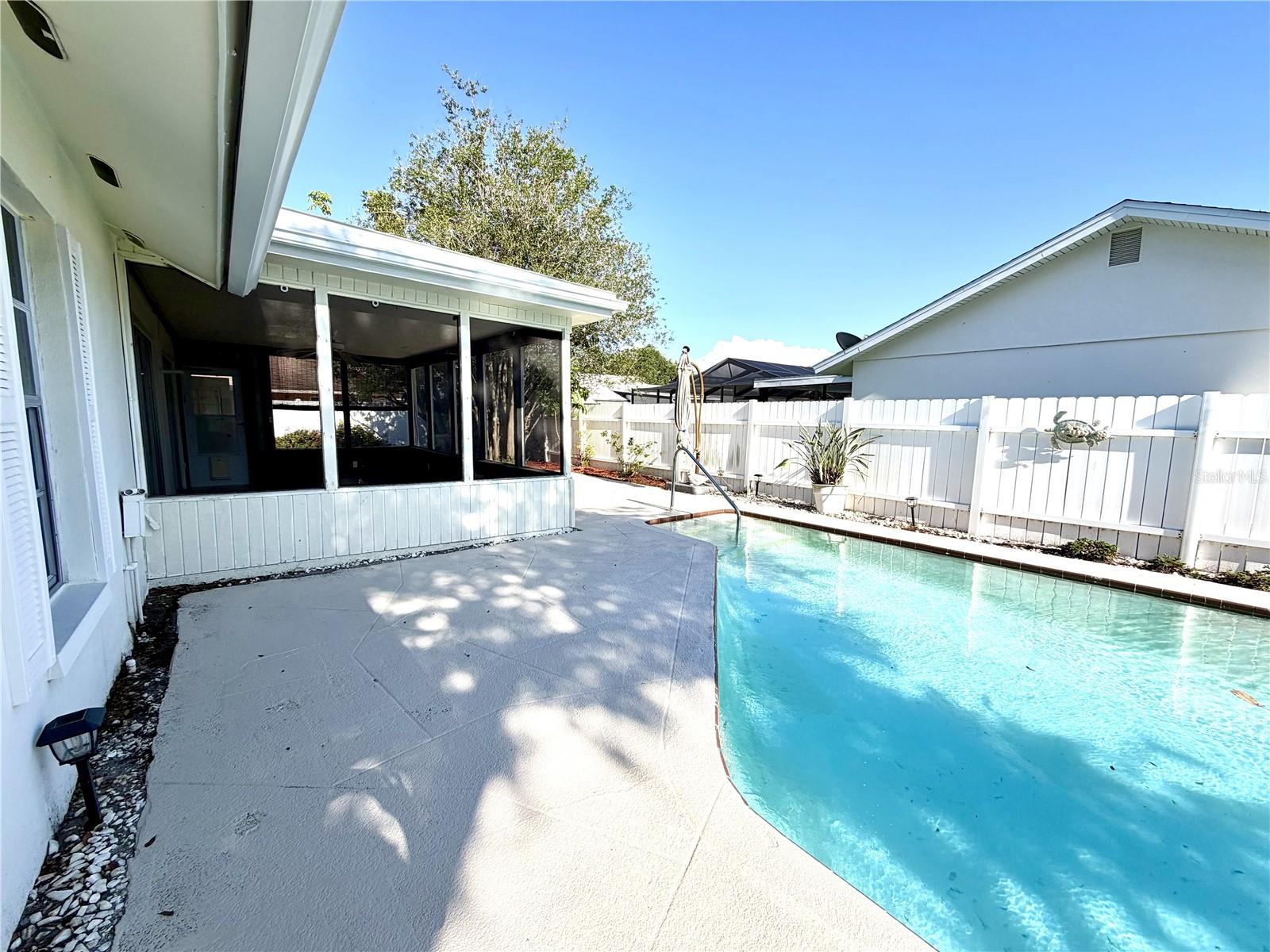 Screened patio overlooks pool area