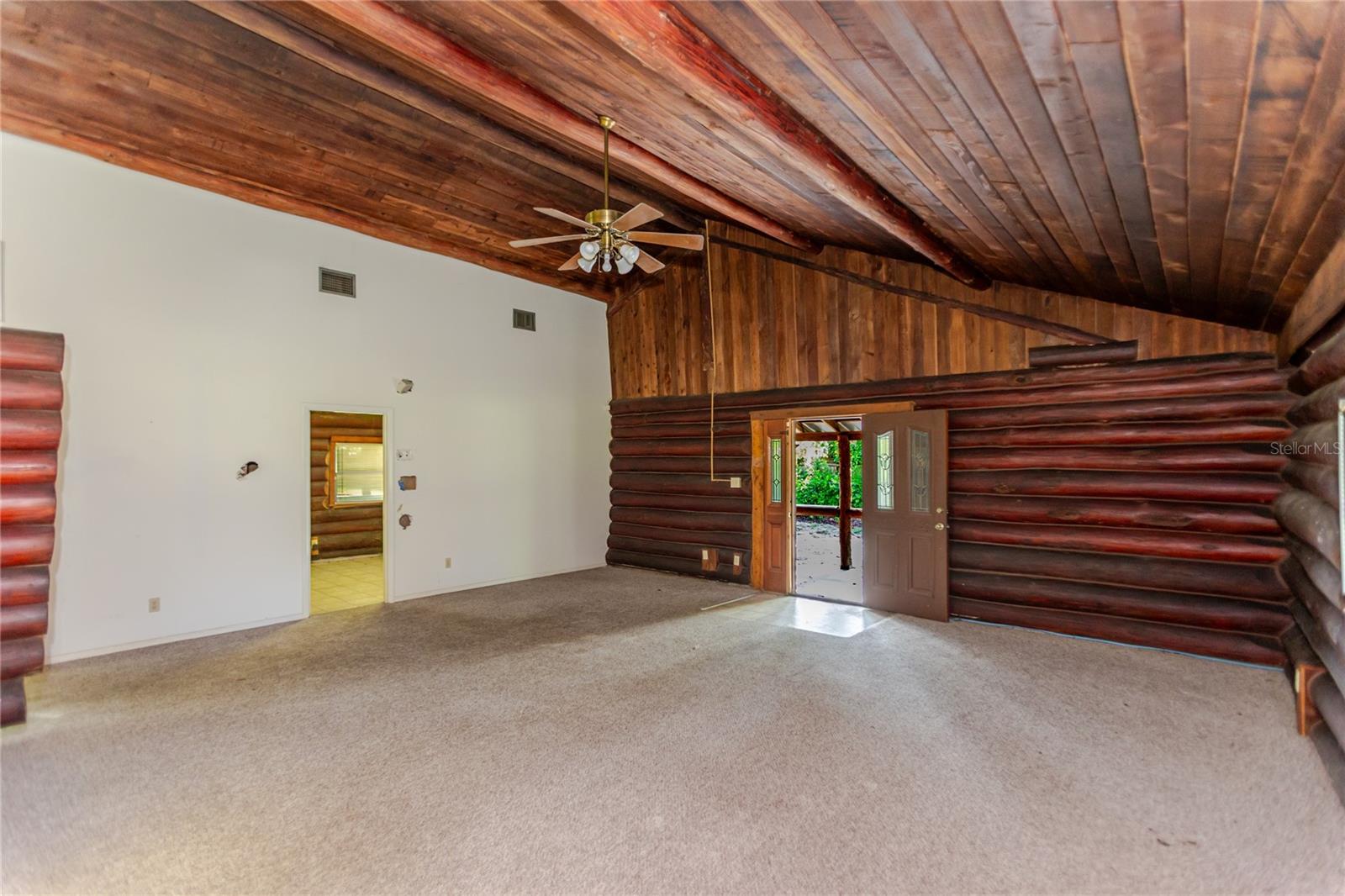 Living Room with Wood Beamed Ceiling & Walls