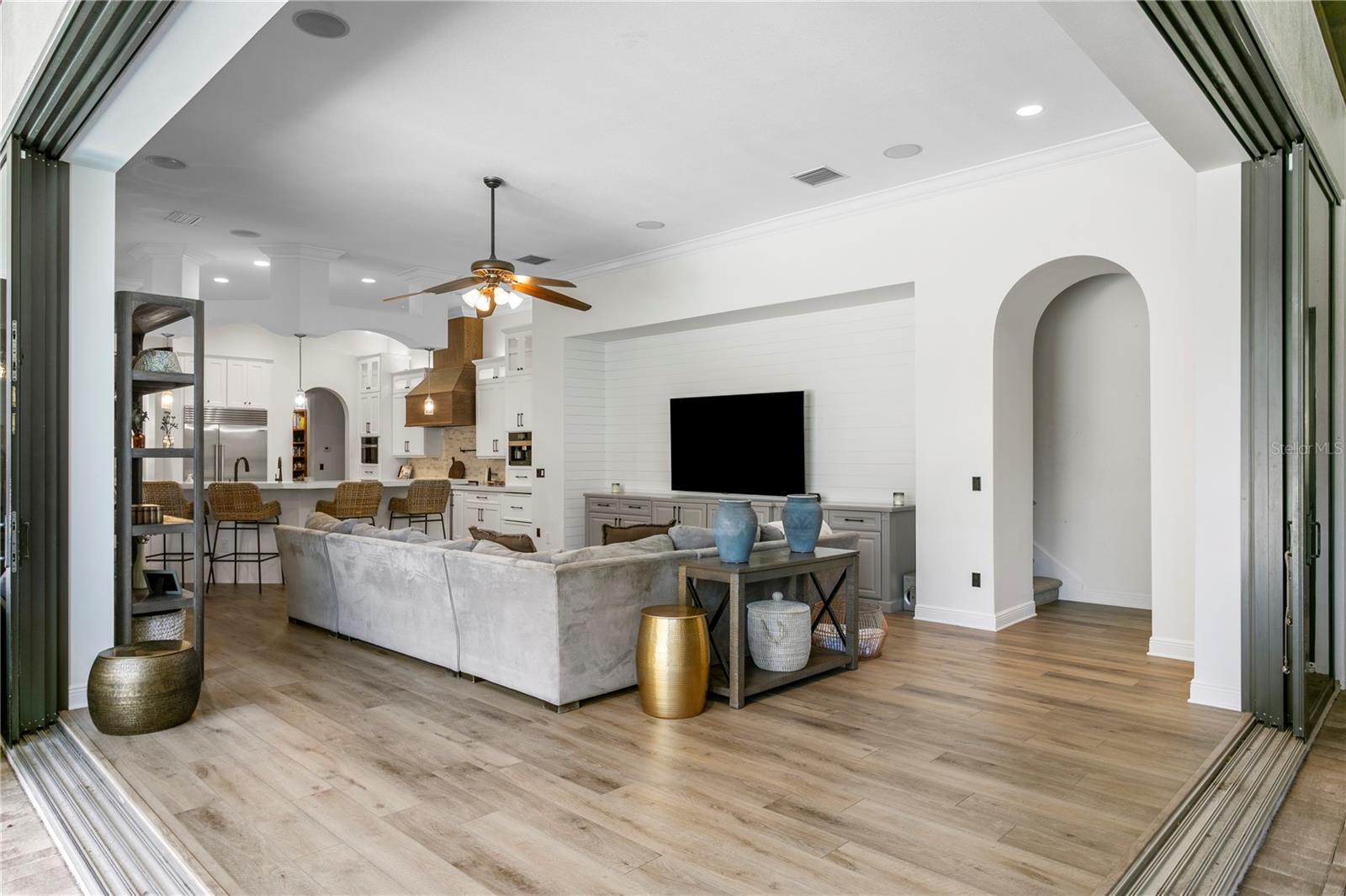 Rich travertine flooring in main living spaces.