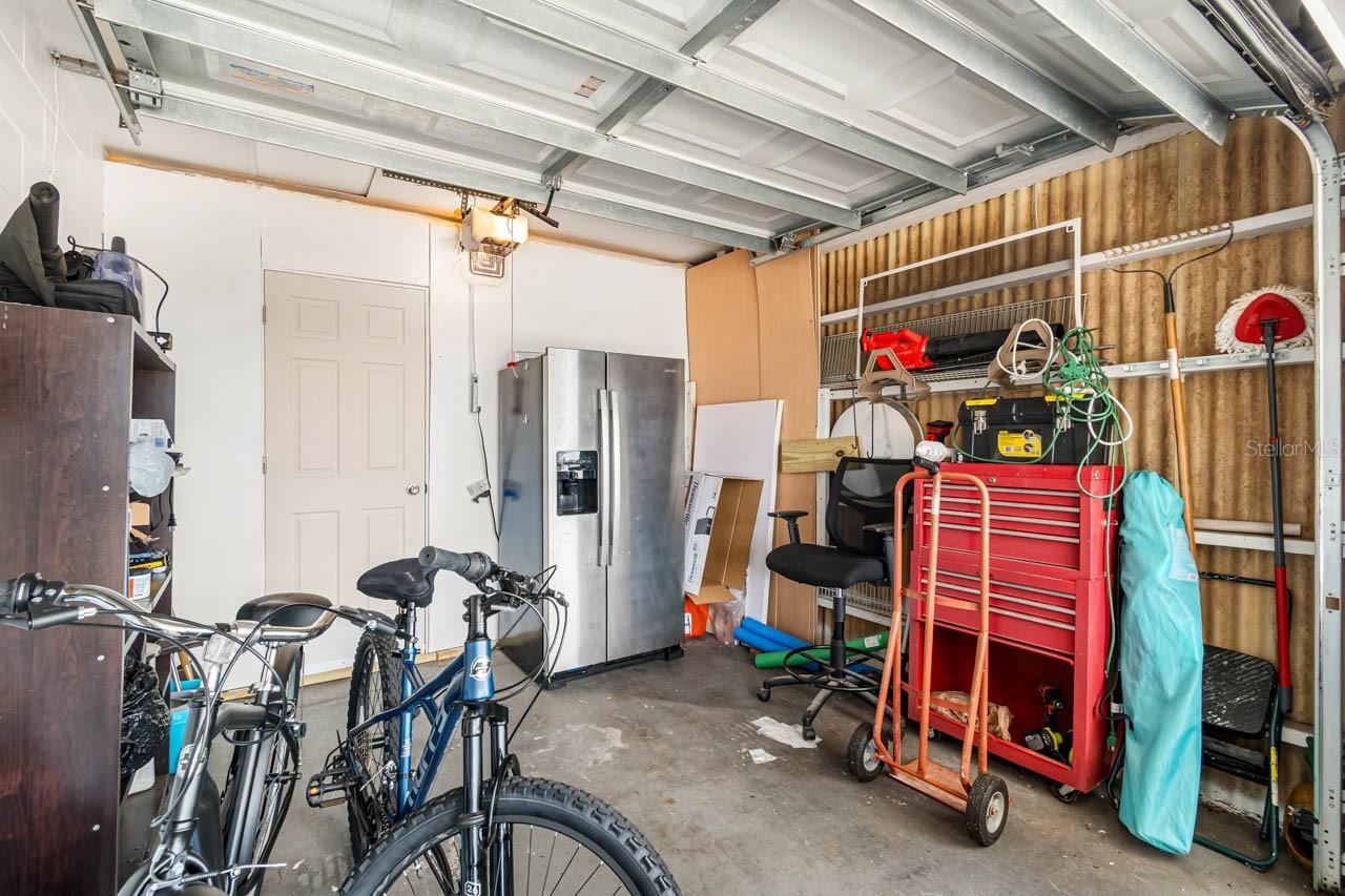 Walk-in closet behind golf cart garage