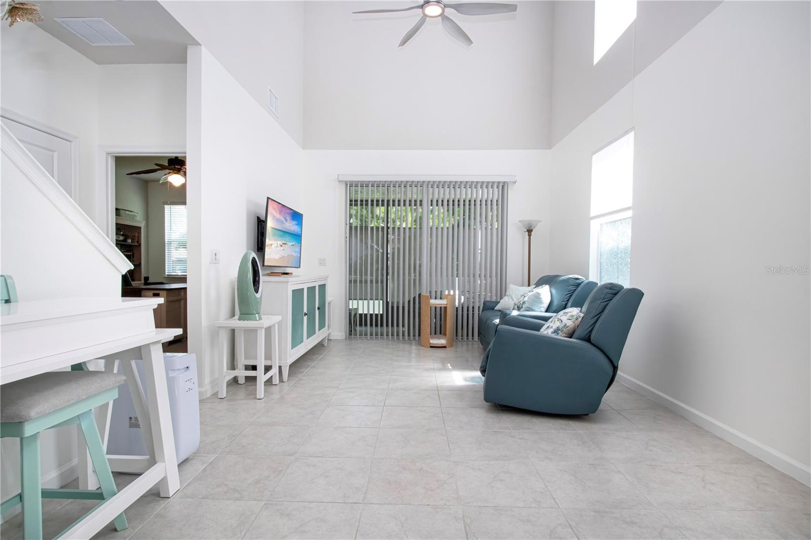 Lanai through the sliding glass doors, Guest 1/2-bath & Primary bedroom on the left