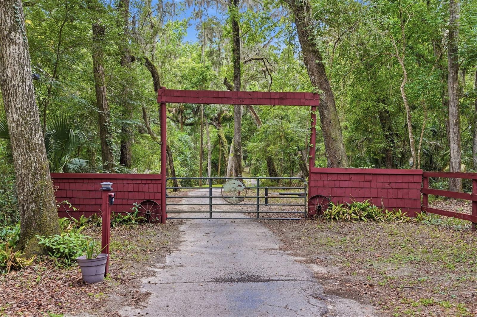 Gate and paved driveway to the hilltop cabins