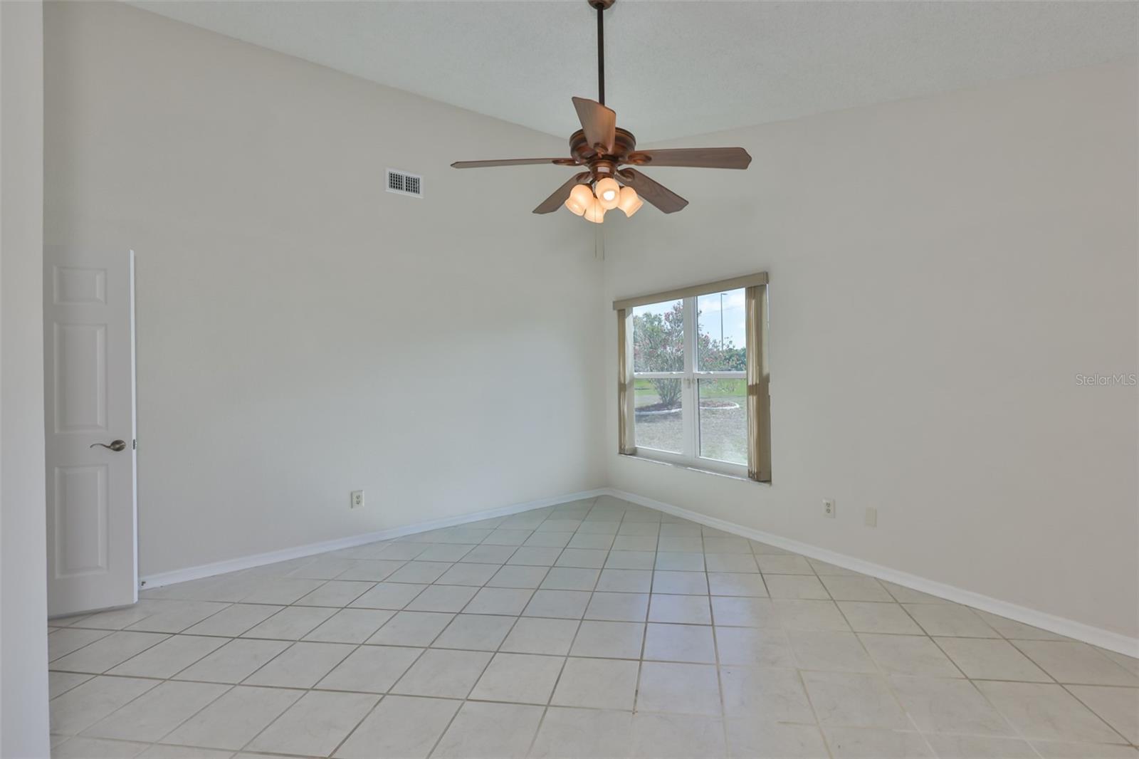 Primary Bedroom with Garden view, ceiling fan, window treatments