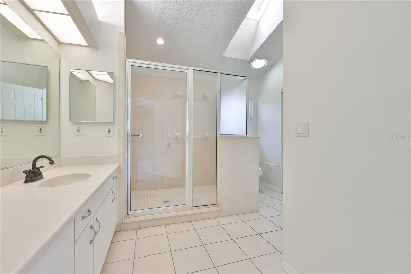 Primary Bath with garden tub, stall shower, makeup vanity