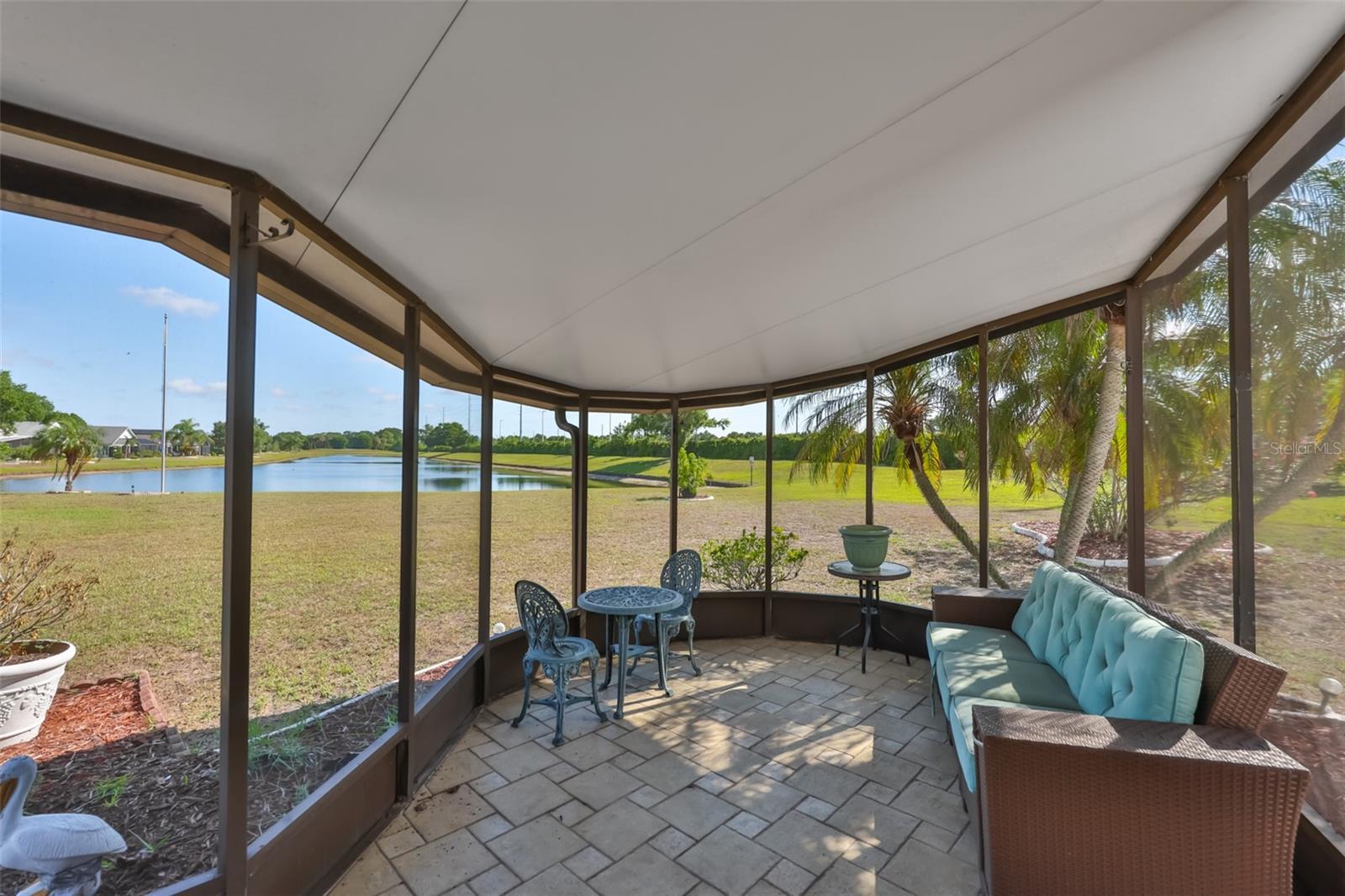 Screened lanai, your relaxing spot coffee  or cocktail spot with garden and water views - and no rear neighbors!