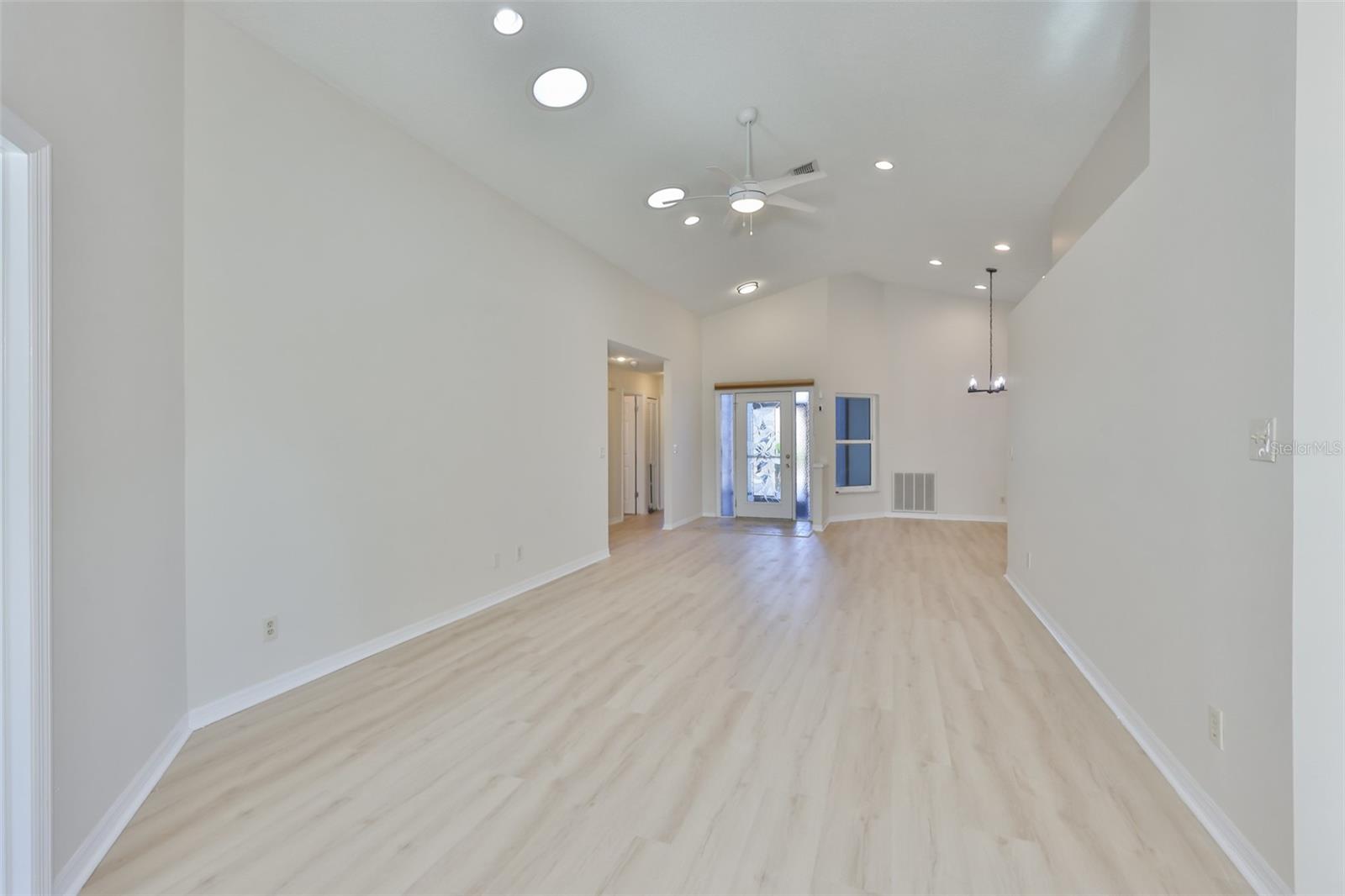 Great Room to Foyer; solar tubes, recessed lighting, ceiling fan, upper decorative built-in shelf