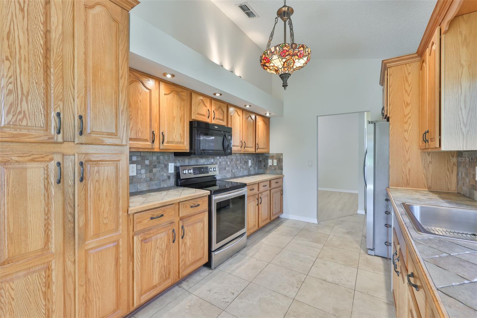 Galley Kitchen, stainless range and refrigerator