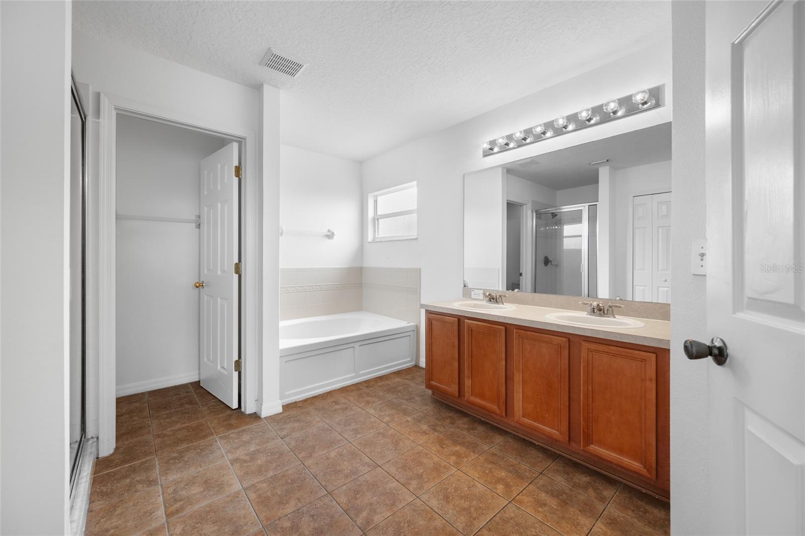 Primary Bedroom En Suite with Walk-in Closet, Tub, Separate Shower, Double Sinks Vanity, Toilet Closet