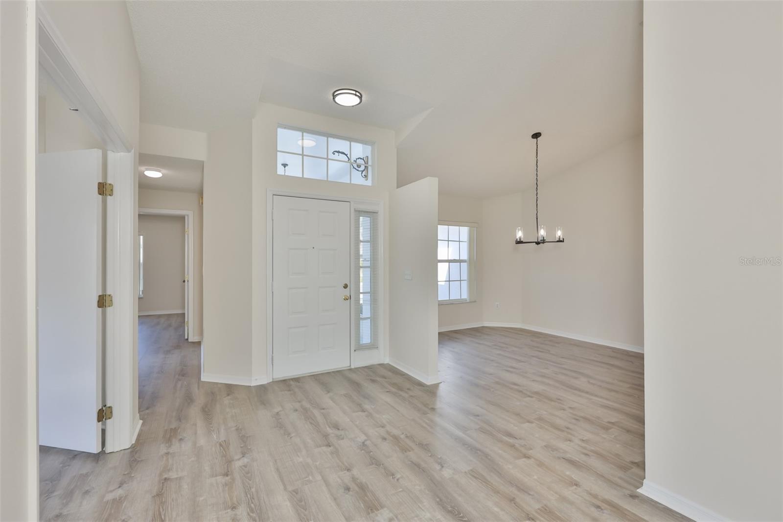 Den/office on left with double doors, Bedroom 2 and Bath 2 left rear, dining room right