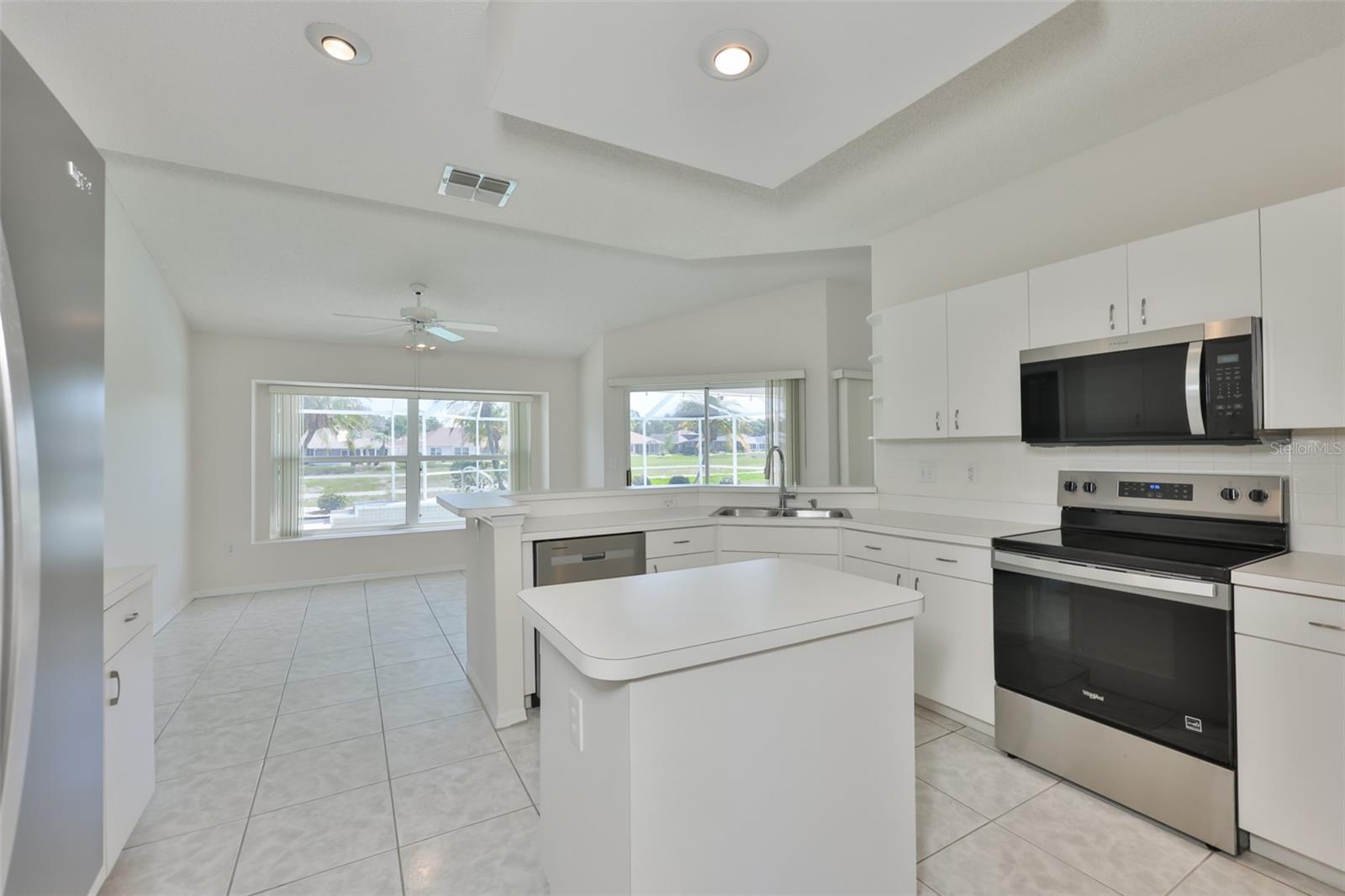 Amazing kitchen; island with power, stainless new appliances, recessed lighting and great views! And in the rear, a full window seat!