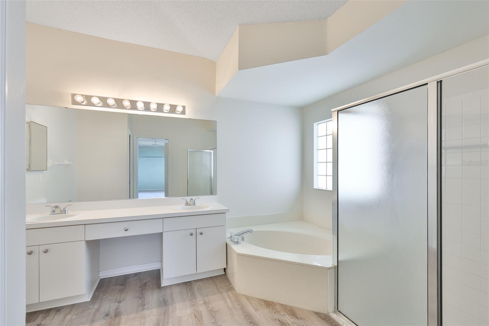 Primary bath; dual sinks, makeup area, garden tub, stall shower.