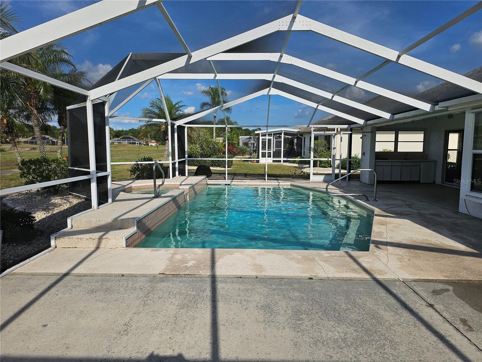 Hot tub, infinity waterfall, pool, covered lanai and outdoor kitchen too! And don't forget the outside shower there too.