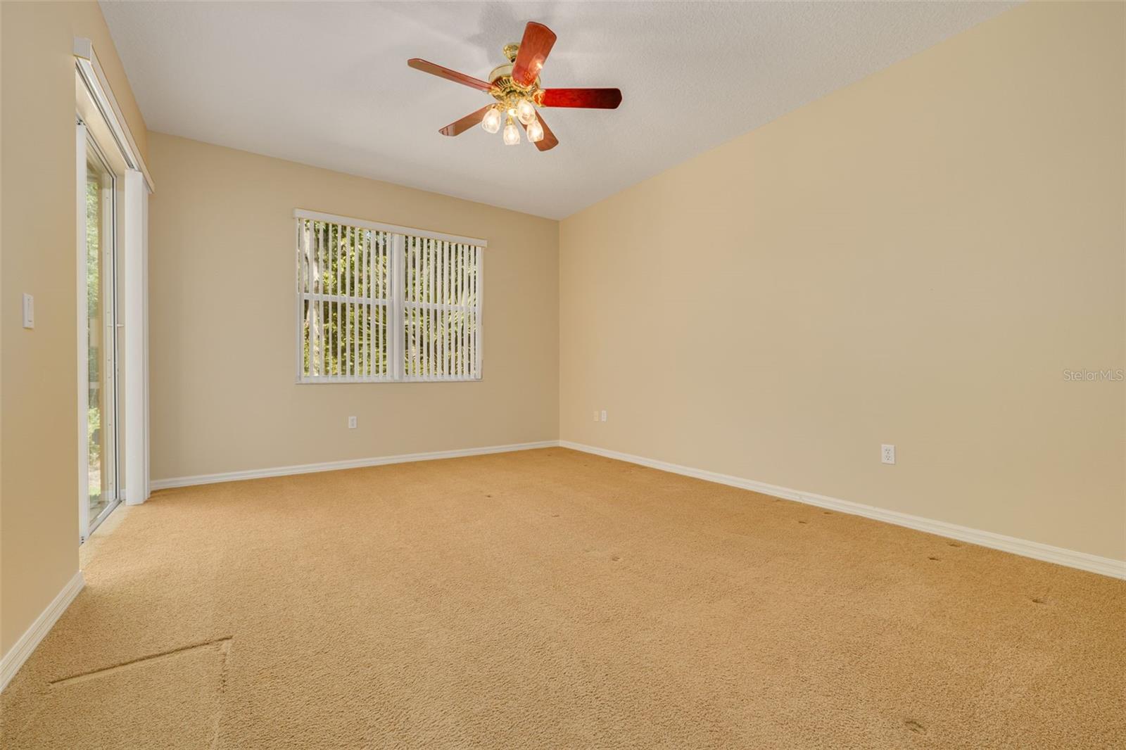 Primary bedroom with sliders on left