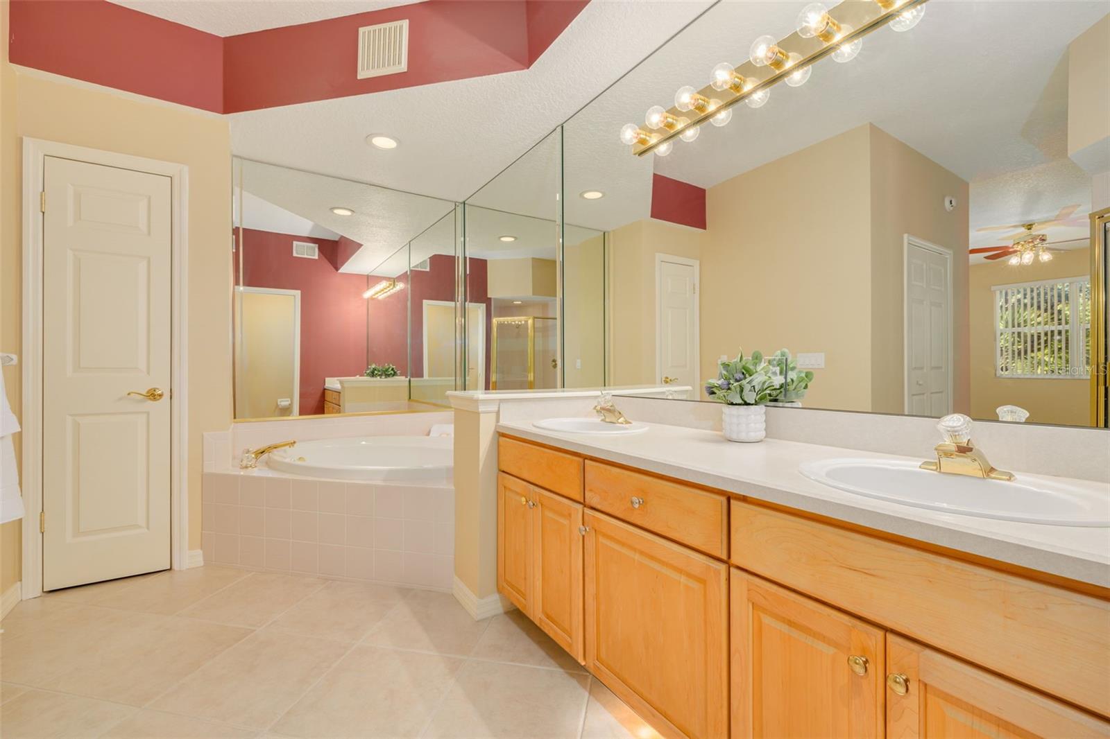Garden tub and dual sinks in the generously-sized primary bathroom.