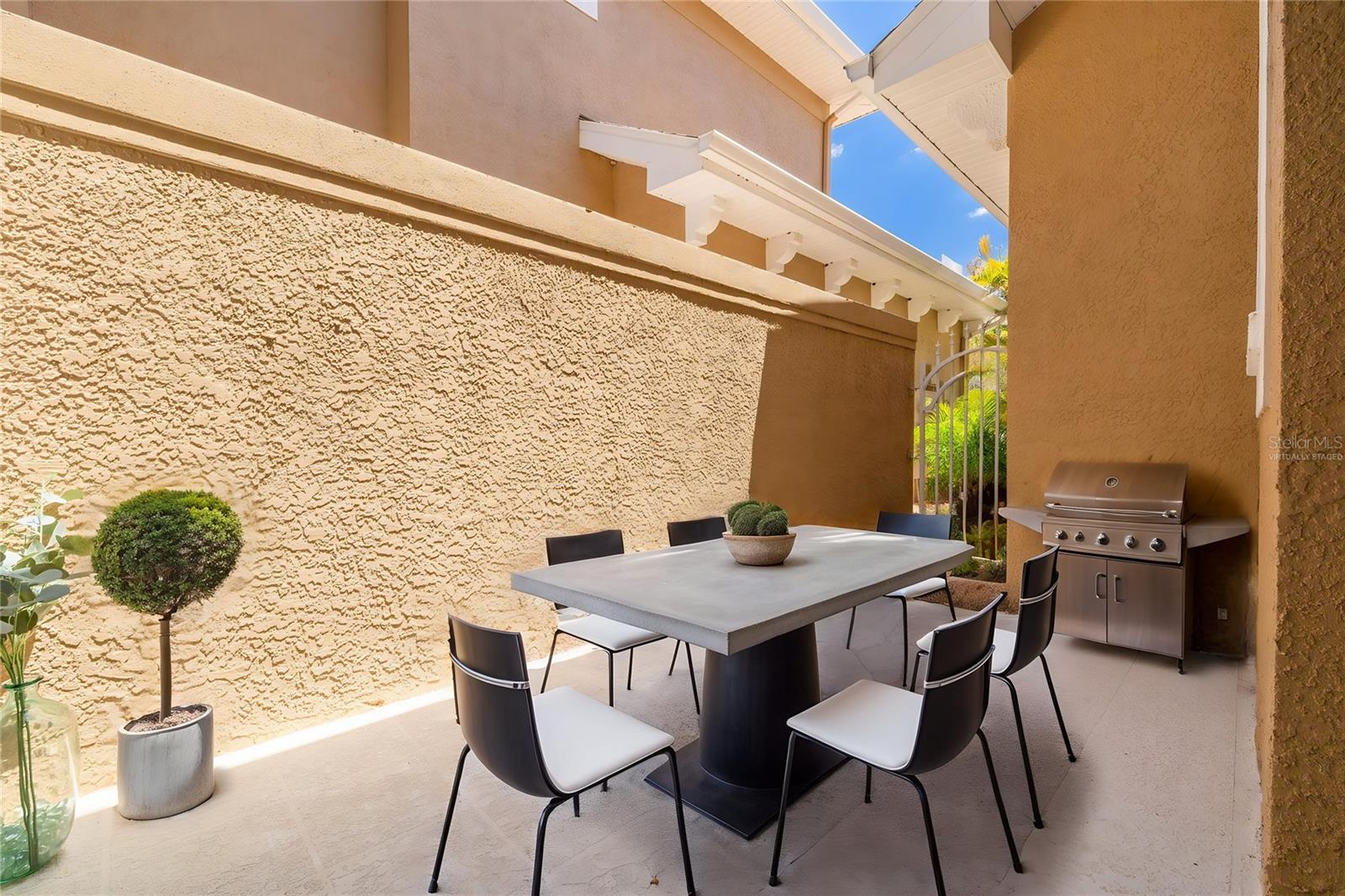 Gated courtyard, virtually staged; electric BBQ is allowed