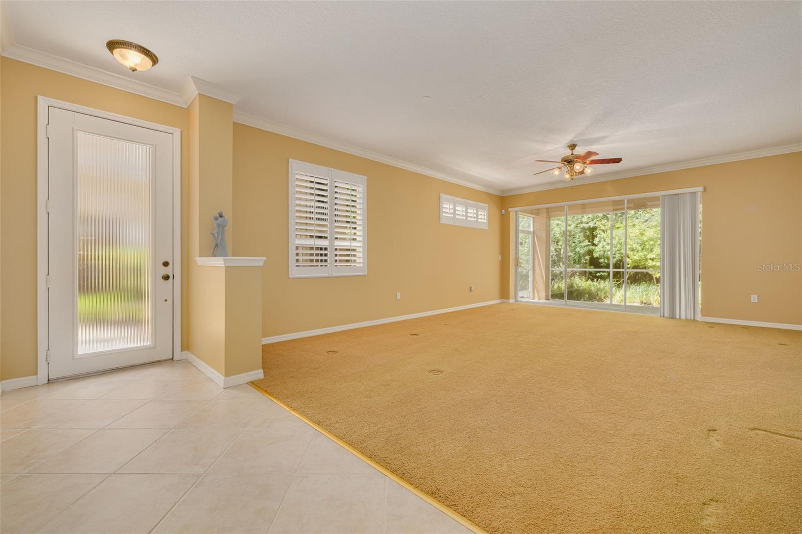 Living room with sliders to the lanai that overlooks conservation!