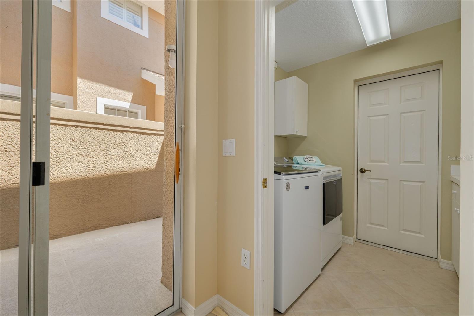 Inside laundry, with newer washer and dryer