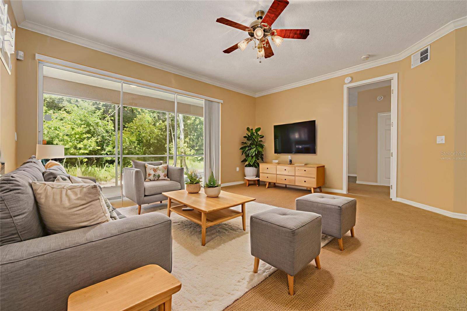 Living room - virtually staged - with primary bedroom on the right