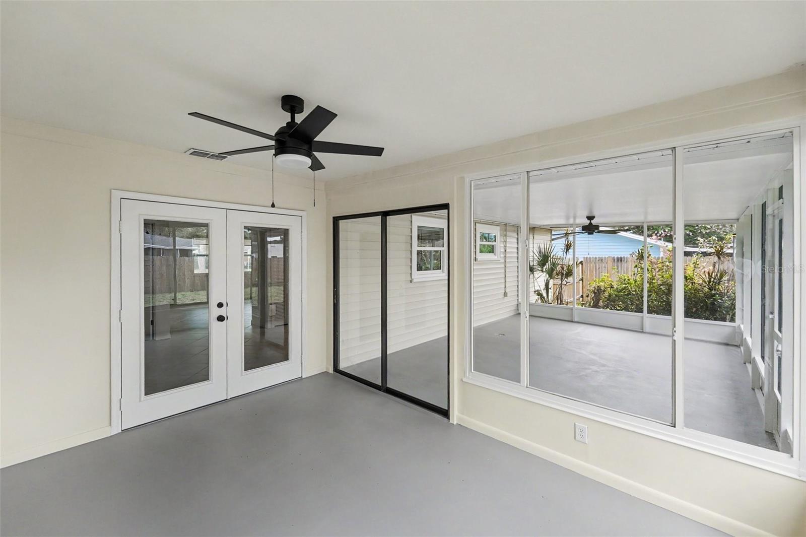 Florida Room Looks Out To Screened-In Patio