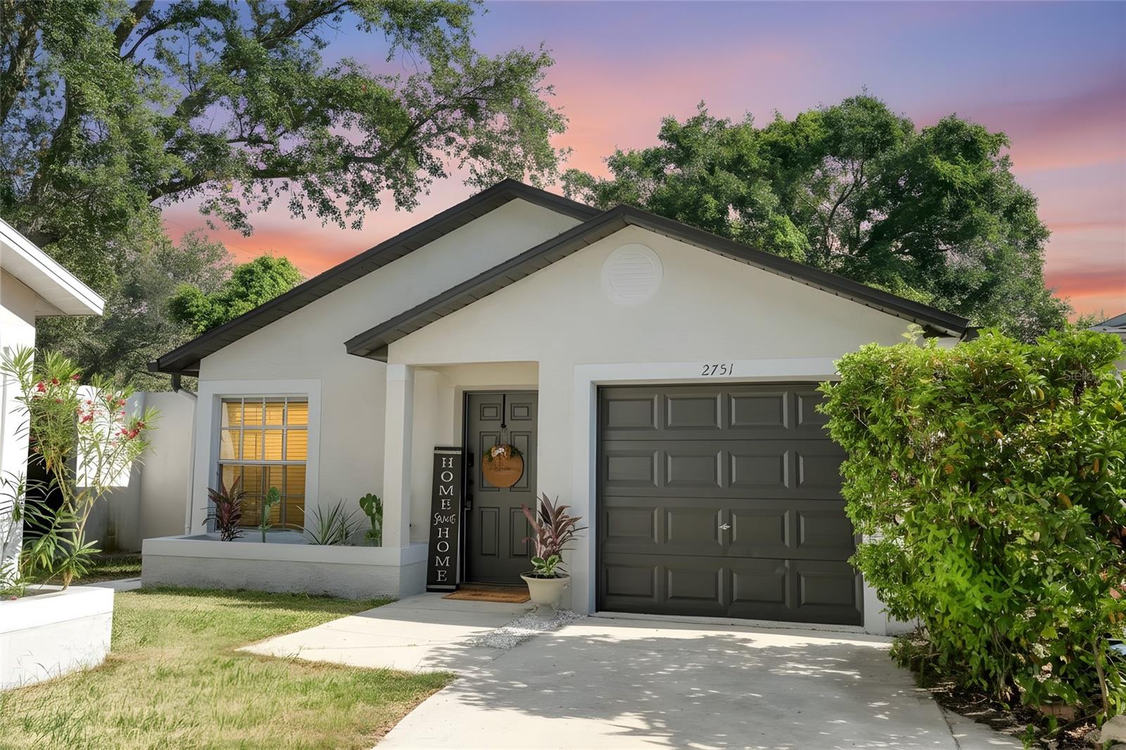 Charming Palm Harbor home featuring excellent curb appeal,  3 Bedrooms, 2 Bathrooms, a one-car garage, and a welcoming front entry.