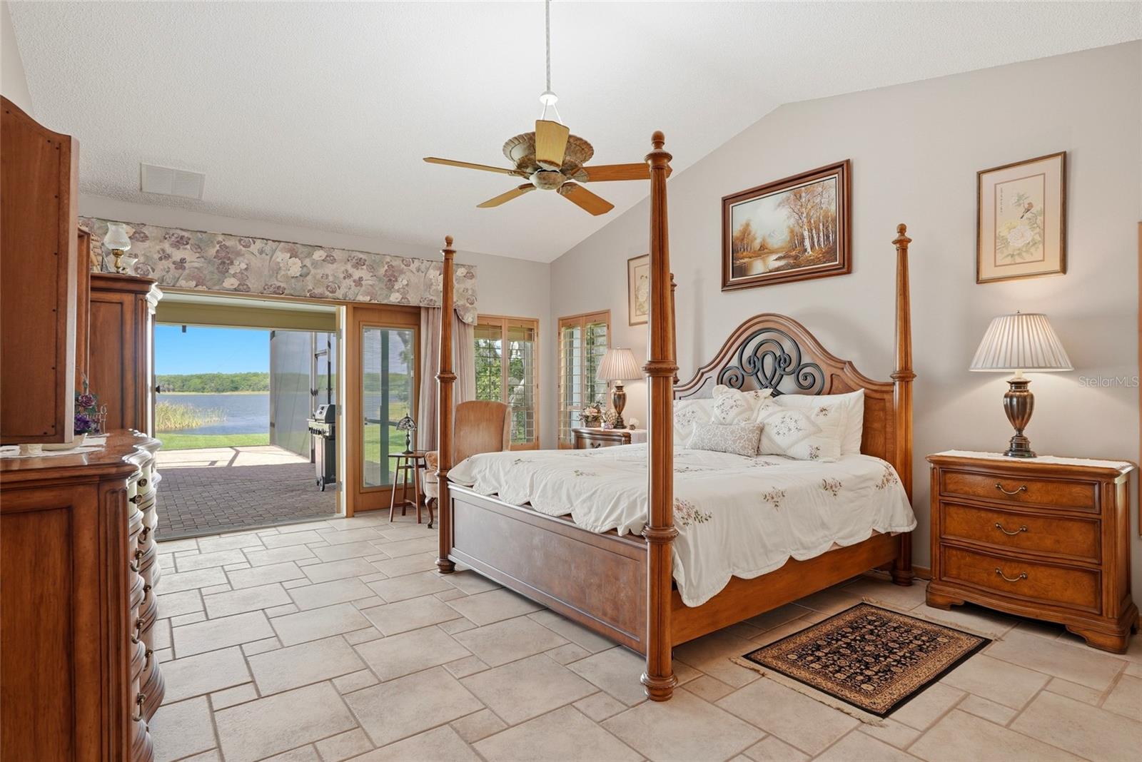 Primary Bedroom withhurricane impact rated Frenchdoors to the enclosed pool.Start every morning withstunning views of the lake.
