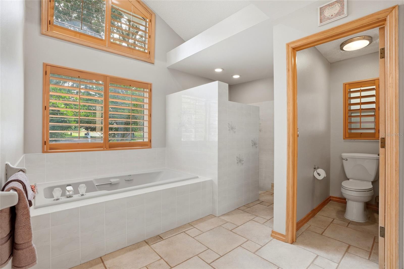 Primary Bathroom ensuite withWhirlpool tub and separatewater closet and shower
