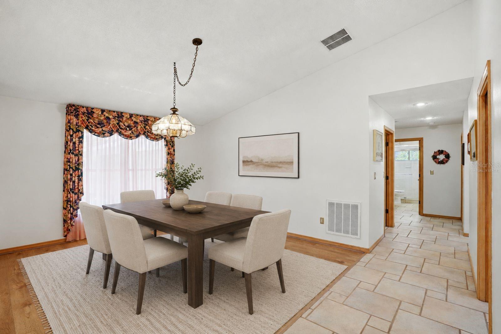 Dining room, to the right arebathroom 2 and bedrooms 2and 3, both with stunning lakeviews-virtually staged