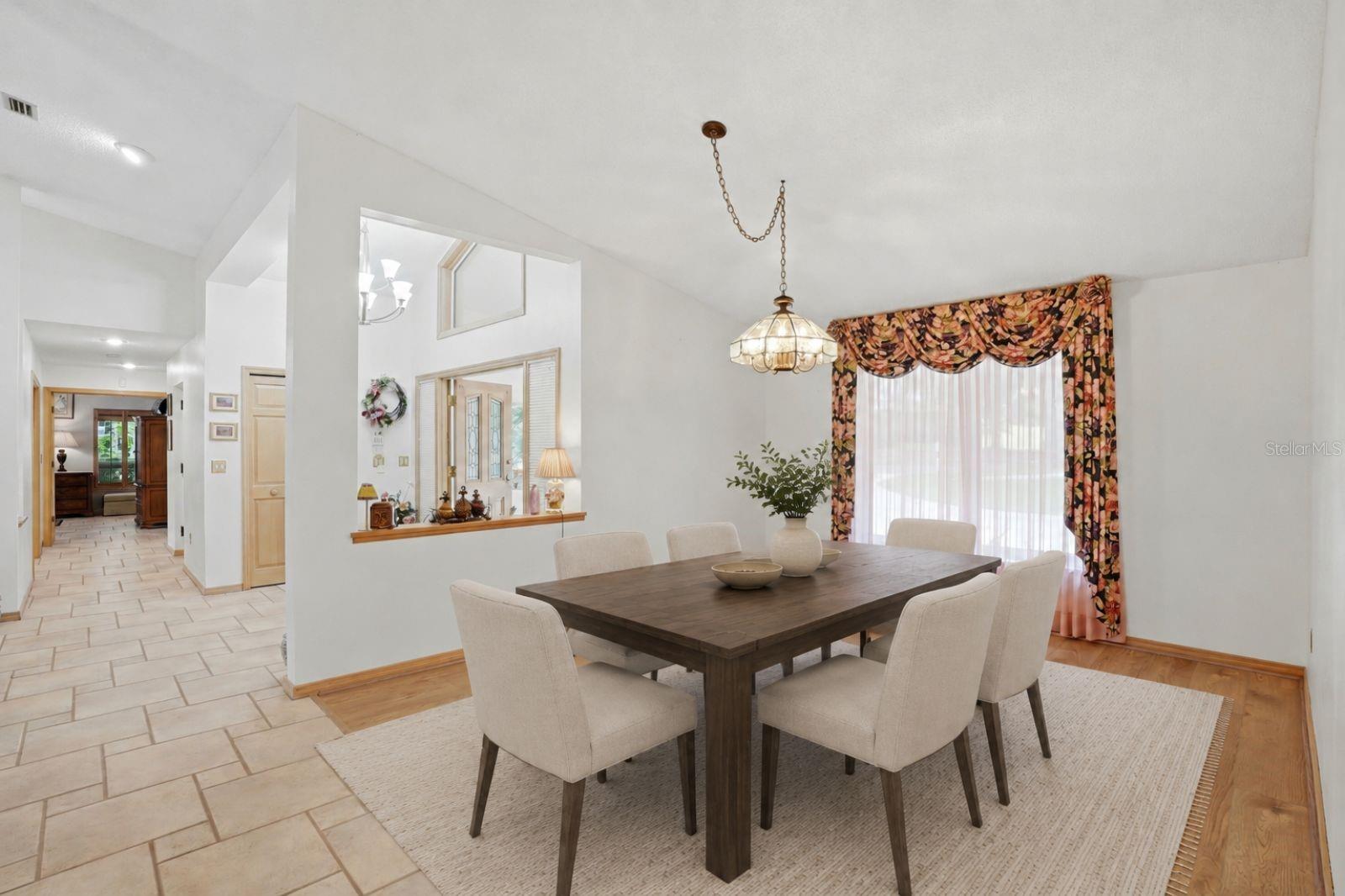 Dining room, to the left yourprimary with ensuite andbonus room, both withbeautiful lake views-virtuallystaged