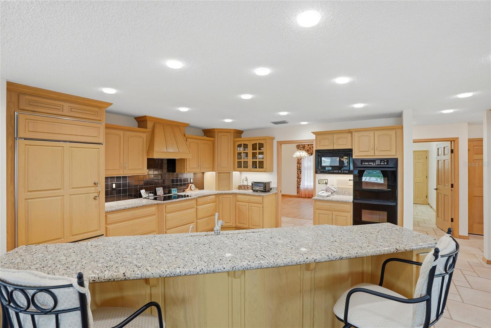Updated kitchen with Sub-Zerorefrigerator · Double ovens ·Granite countertops · Customcabinetry