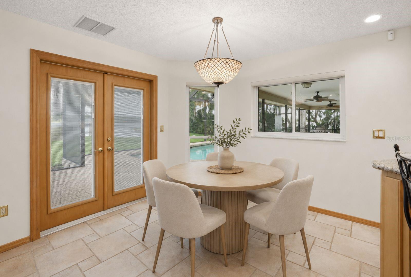 Your breakfast areaoverlooking the Lake and poolwith convenient pass throughwindow to the outdoor kitchen.Hurricane impact rated Frenchdoors and windows-