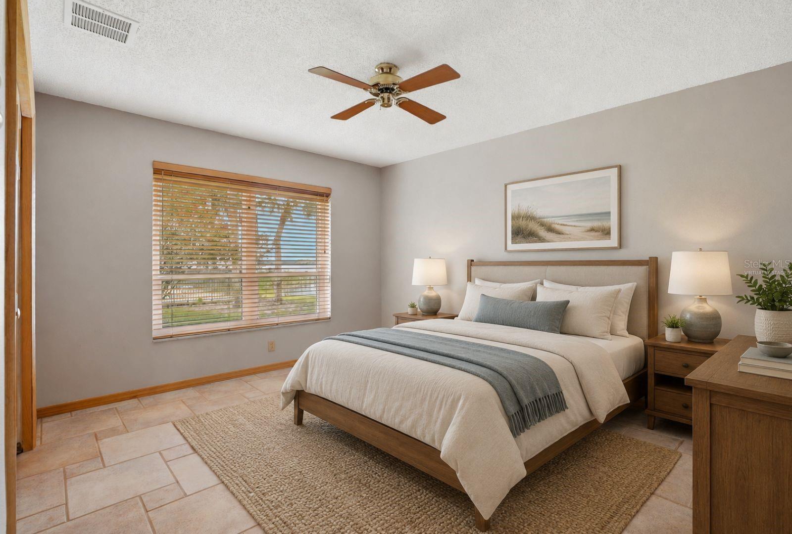 Bedroom 2 With Lake view andhurricane impact ratedwindow-virtually staged