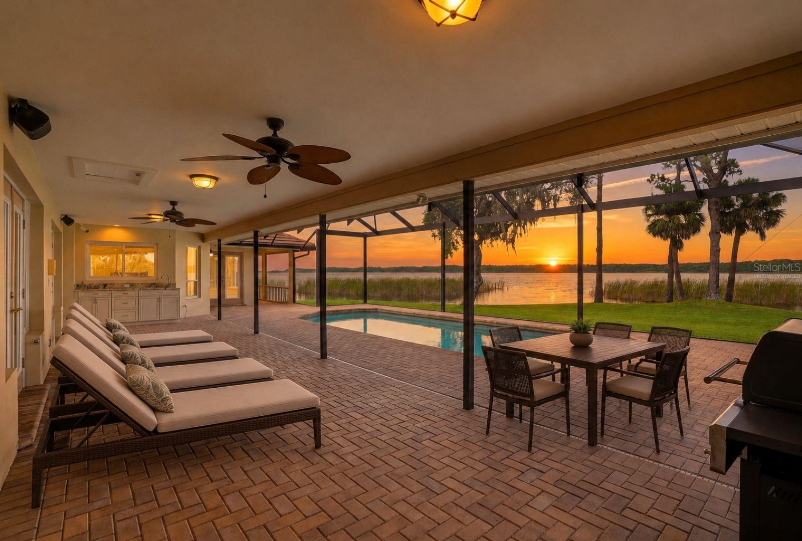 These views, the sunrise everyday. Covered Lanai and highvelocity pool enclosure withpaver pool deck and PebbleTecpool offers year roundenjoyment-virtually staged