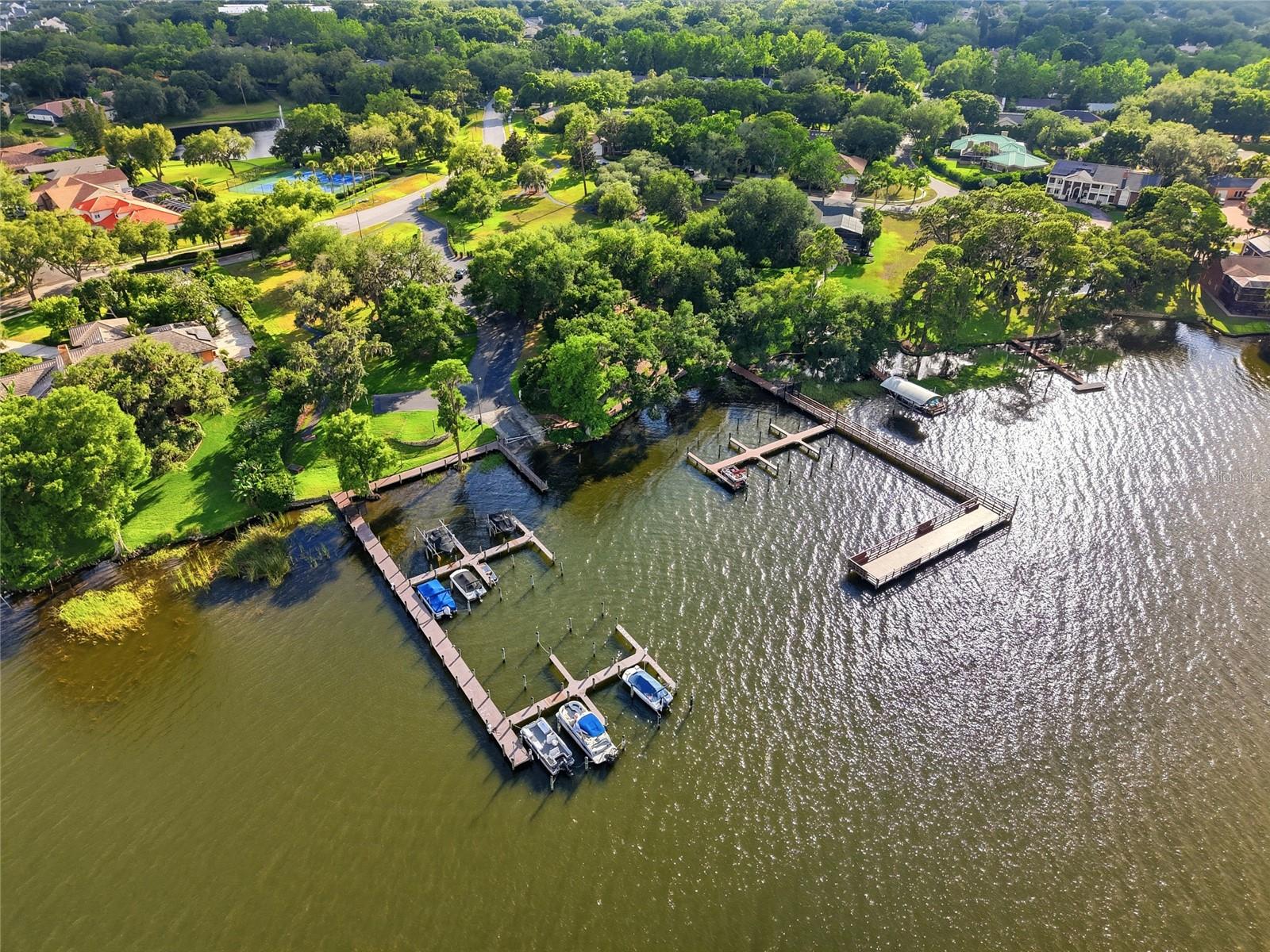 Residents enjoy a private gatedmarina with boat slipsavailable on Lake Tarpon and agated boat ramp, a privategated community pier, a nineacre common area park, awalk-out gazebo overlooking alarge pond with a fountain,paved walking pathsthroughout the common areas,a playground, two gated tenniscourts, and a basketball court.