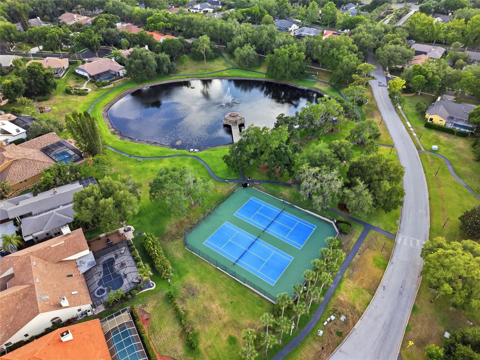Residents enjoy a private gatedmarina with boat slipsavailable on Lake Tarpon and agated boat ramp, a privategated community pier, a nineacre common area park, awalk-out gazebo overlooking alarge pond with a fountain,paved walking pathsthroughout the common areas,a playground, two gated tenniscourts, and a basketball court.