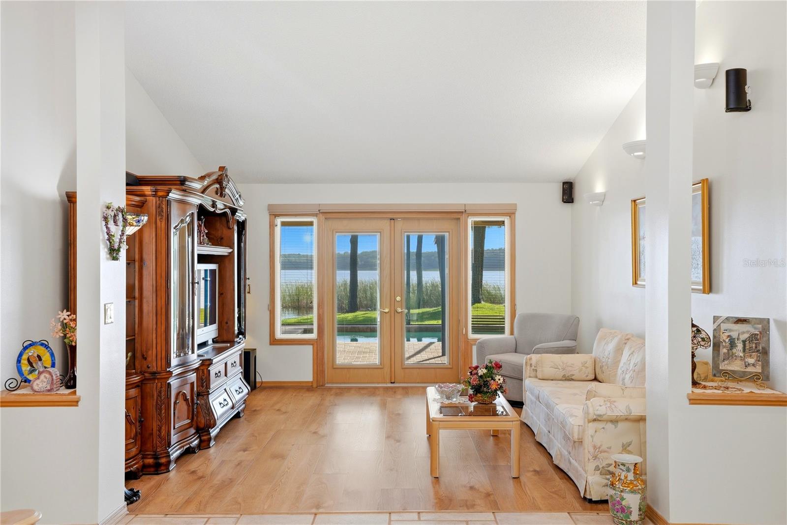 Living Room with hurricane impact ratedFrench doors to the enclosed pool.