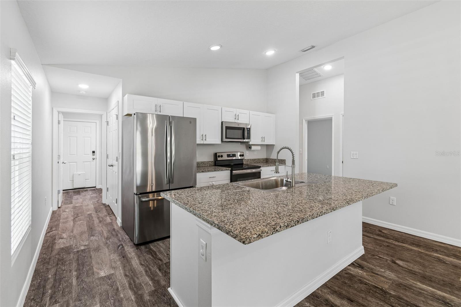 Kitchen and Hallway Leading to Laundry/Garage